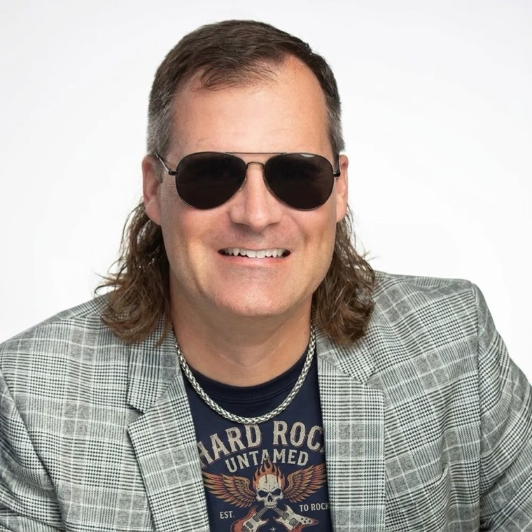 Scott Ingram in a mullet wig and sunglasses